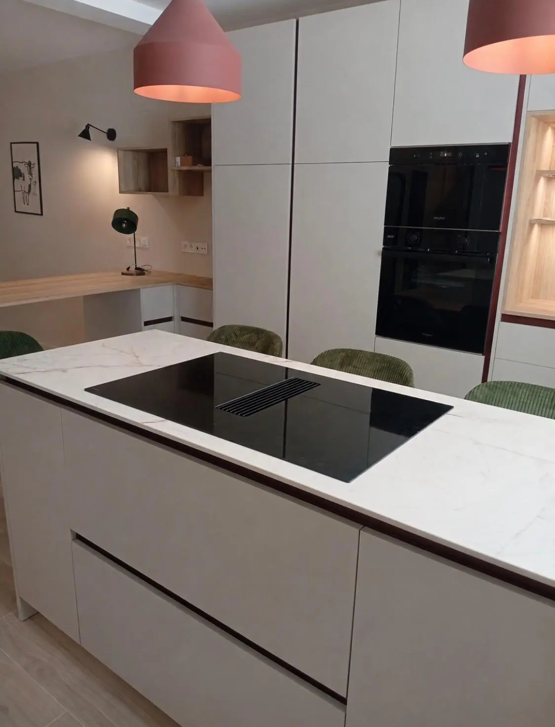 Isla de cocina con encimera de piedra clara veteada y placa de inducción integrada